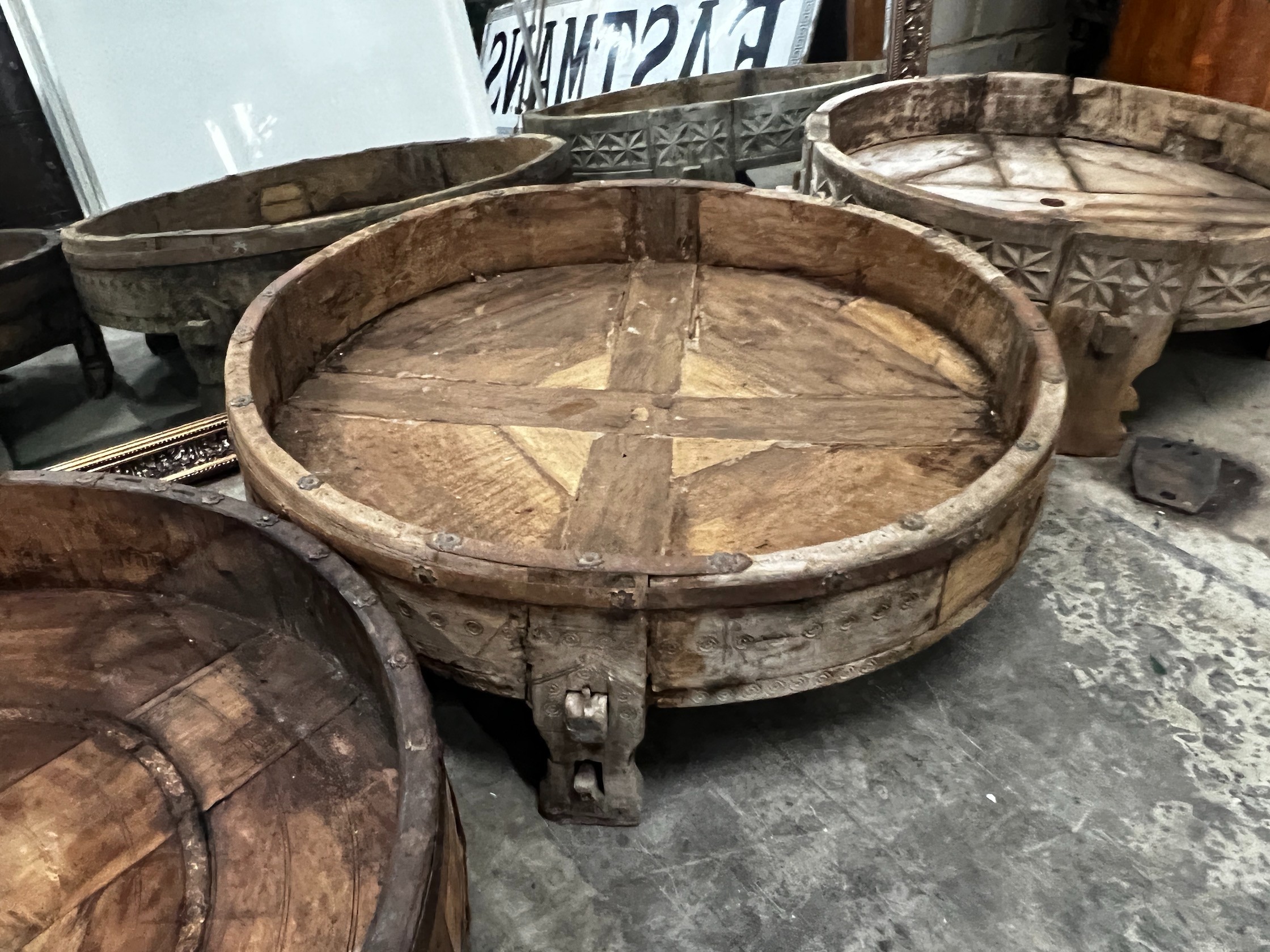 Four chip carved mazers, largest diameter 76cm, and a pair of Afghan stools